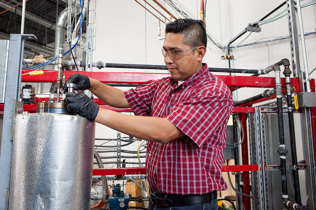 OxEon engineer installing small scale plasma reformer for syngas production.